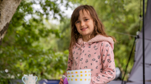 Young girl in her pyjamas camping